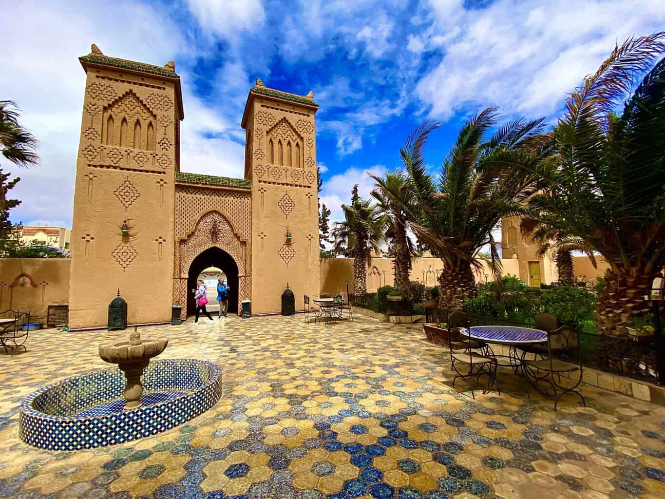 Kasbah entrance with inner courtyard with sunflower patterned tile in Morocco