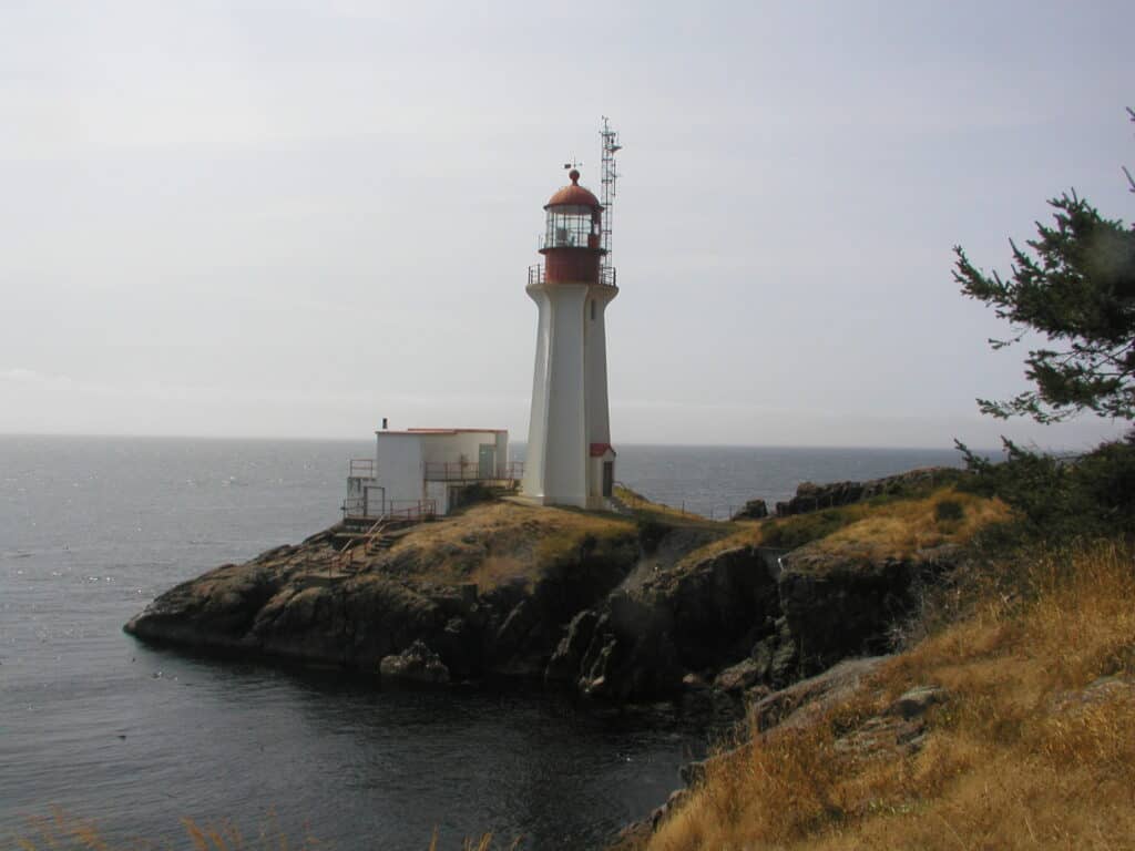 BC Lighthouse with red dome and ocean in background