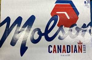 Packaging for Molson Canadian 24 pack of beer with red and blue writing