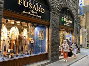 Florence storefront with designer clothes and two women walking along the street