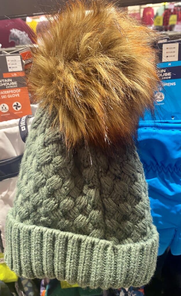 Green woolen toque with furry top