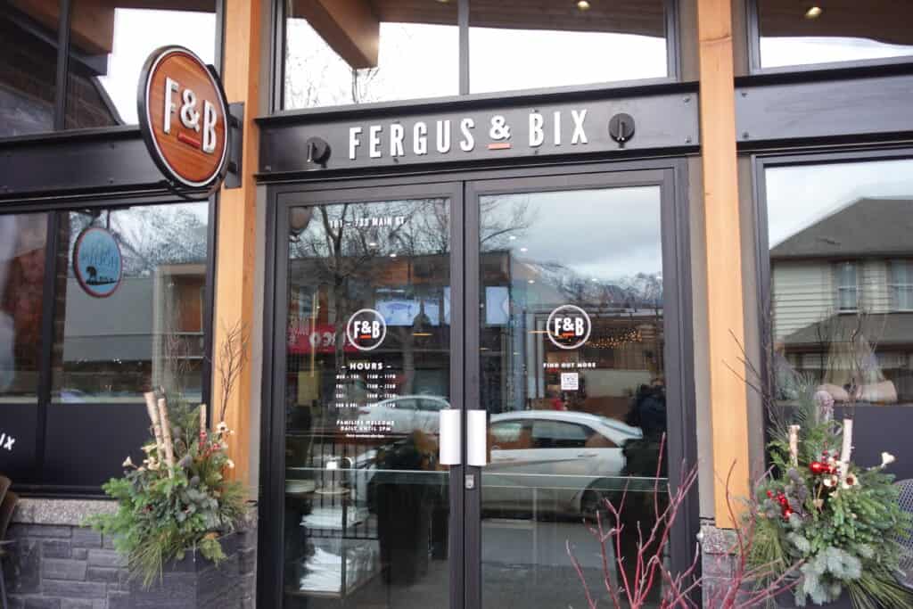 Fergus and Bix sign on restaurant with glass double doors in Canmore