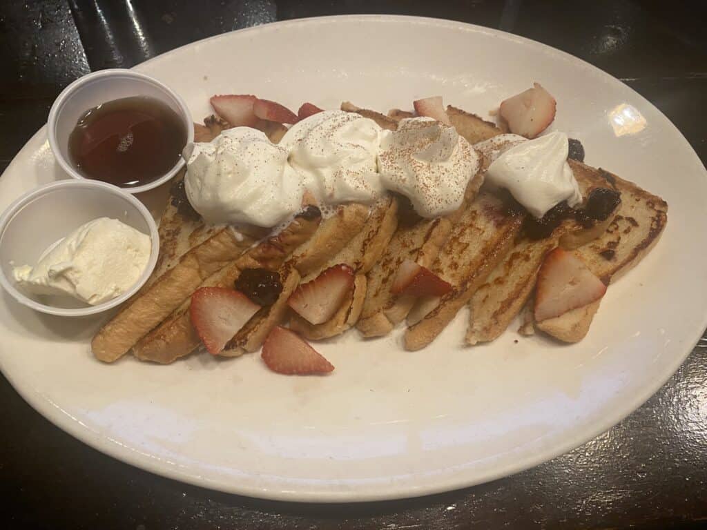 French toast with whipped cream and maple syrup