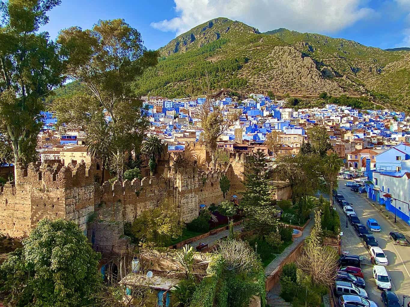 Chefchaouen town with Atlas mountains in the background and kasbah in the forefront